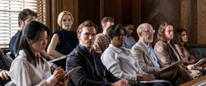 Scene from Clint Eastwood’s Juror #2, featuring the jury, including Nicholas Hoult, in a tense courtroom drama exploring guilt and morality.