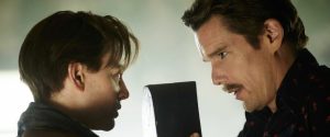 Sarah Snook and Ethan Hawke in a tense scene from Predestination (2014), with Snook's character holding a mysterious black case while facing Hawke's intense gaze.